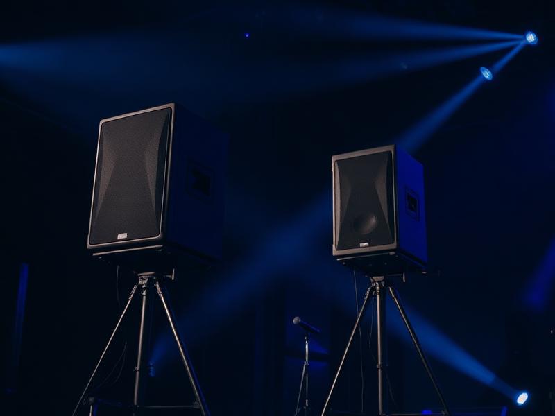 Professional PA speakers on stage with blue lighting